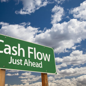 Cash Flow Green Road Sign Over Dramatic Clouds And Sky