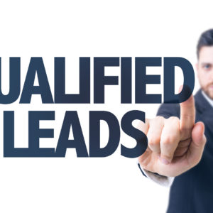 Business man pointing the text: Qualified Leads